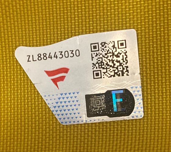 A close-up of a Sports Integrity 2007 Open Championship Carnoustie PGA Issued Golf Flag Fanatics sticker, showing the code ZL88443030, a red logo, two QR codes, and a blue F on a yellow textured background.