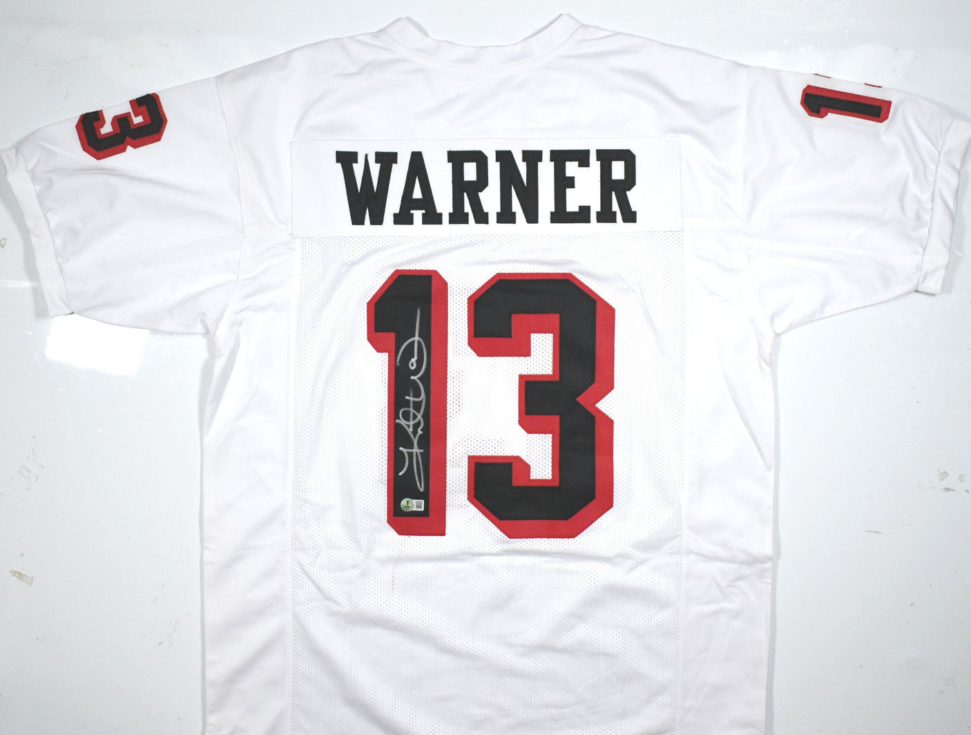 Kurt Warner Autographed White Pro Style Jersey-Beckett W Hologram *Silver