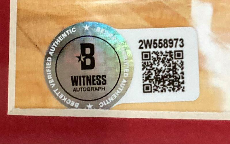 The Allen Iverson Signed Framed 8x10 Philadelphia 76ers Photo vs Michael Jordan by Sports Integrity features a holographic B Witness Autograph seal, barcode label 2W558973, and a QR code, placed on a wooden surface.