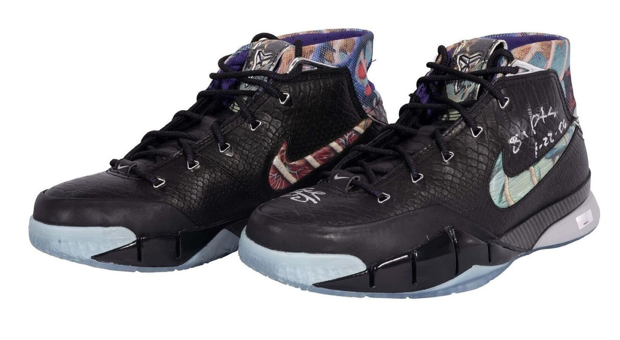 A pair of black Nike Zoom Kobe I Prelude high-top basketball shoes with textured uppers, multicolored inner lining, icy blue soles, and signed by Kobe Bryant (81 PTS), offered by Sports Integrity.