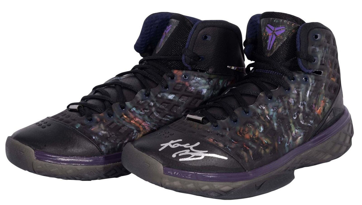 A pair of Kobe Bryant Lakers Signed Nike Zoom Kobe III Prelude Shoes by Sports Integrity, featuring translucent sides, purple accents, the Kobe Bryant logo on the tongue, and a white autograph on one toe.