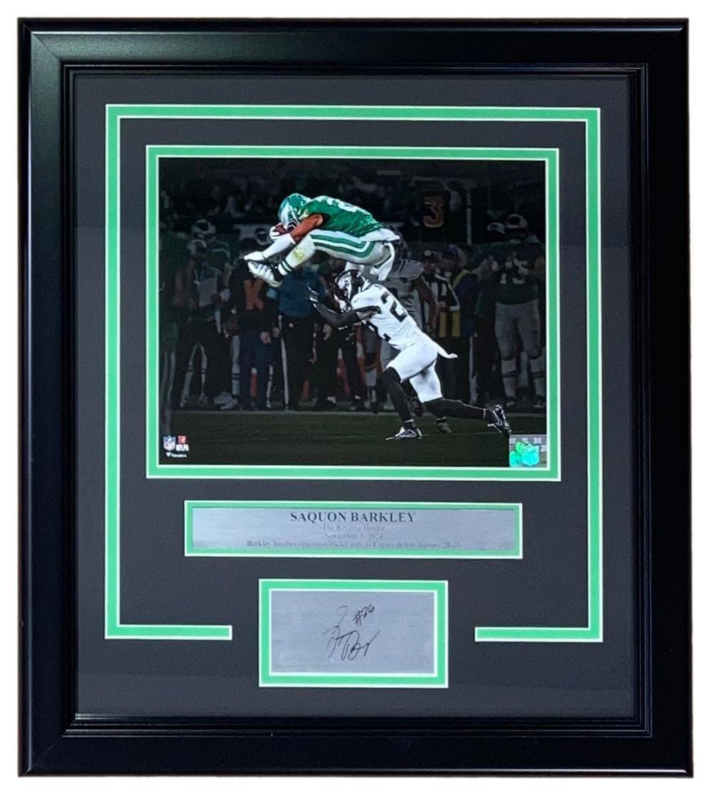 The Sports Integrity Saquon Barkley Framed 8x10 Eagles Reverse Hurdle Photo features a dynamic game moment and includes a laser engraved autograph below the image.