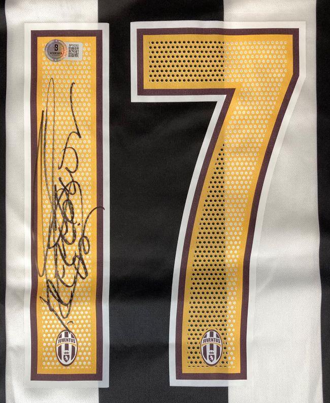 The David Trezeguet Signed Juventus Nike Soccer Jersey BAS by Sports Integrity features black and white stripes, a bold yellow number 17, two Juventus logos, and Trezeguet's autograph beside the number.
