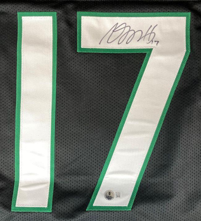 A close-up of the Sports Integrity Davante Adams New York Signed Black Football Jersey BAS shows a green-and-white #17 with a black ink autograph on the 7, plus a small authentication sticker below the number.