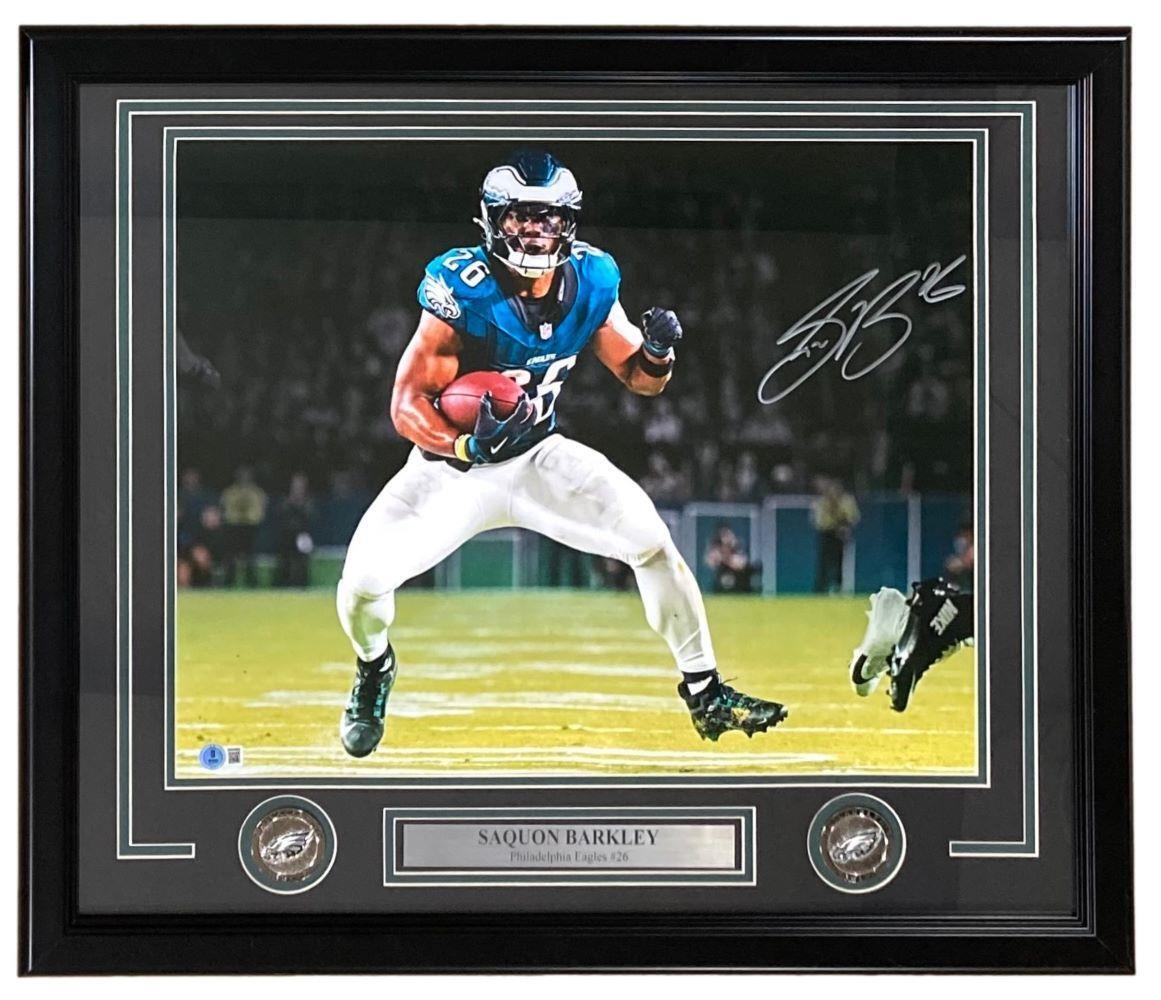 The Sports Integrity Saquon Barkley Signed Framed 16x20 Philadelphia Eagles Photo (BAS ITP) features Barkley running with a football, complete with two commemorative coins and a nameplate below the image.