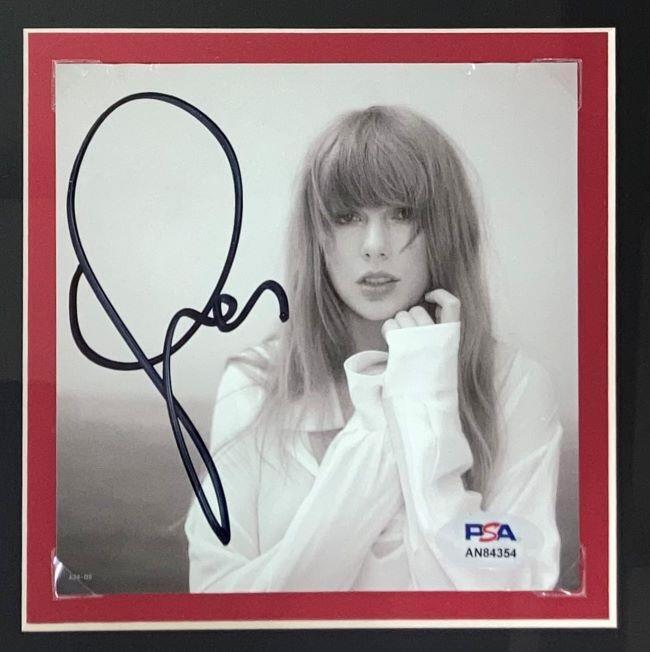 A Taylor Swift Framed Red Football Jersey with a signed insert authenticated by PSA/DNA from Sports Integrity. The display features her signature and includes official authentication details.