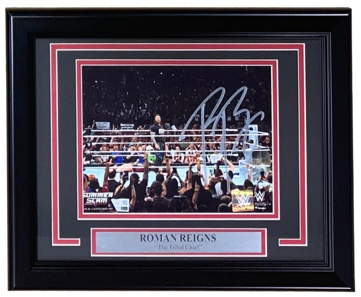 The Sports Integrity Roman Reigns Signed Framed 8x10 WWE Photo features "The Tribal Chief" in the ring at SummerSlam, facing a cheering crowd. Includes a plaque and Fanatics authentication.