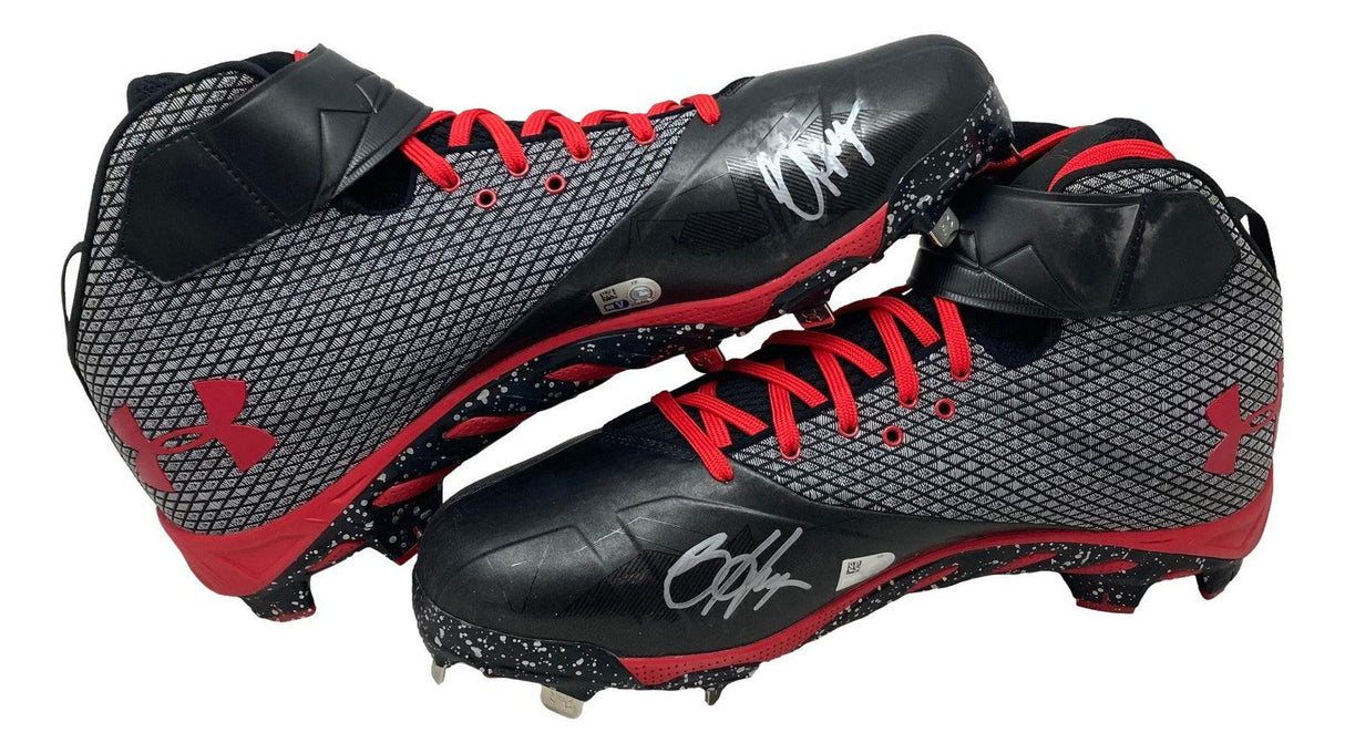 A pair of Bryce Harper signed game-issued Phillies Under Armour cleats, featuring black, gray, and red colors with red laces and white autographs on the sides; offered by Sports Integrity via Fanatics.