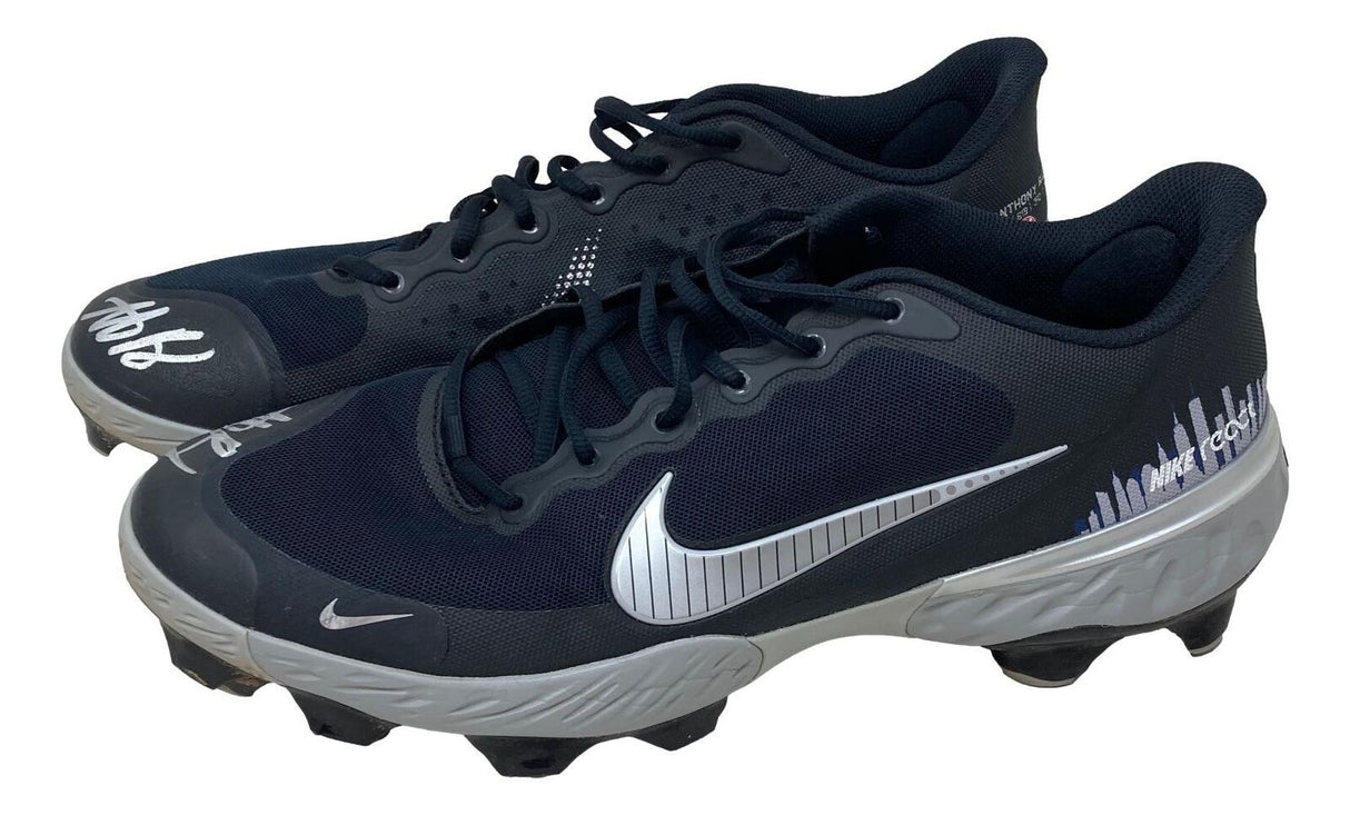 A pair of 2023 game-used New York Yankees Nike cleats, twice signed by Anthony Rizzo, from Sports Integrity—black and gray with silver swooshes, white accents, black laces, and molded studs.