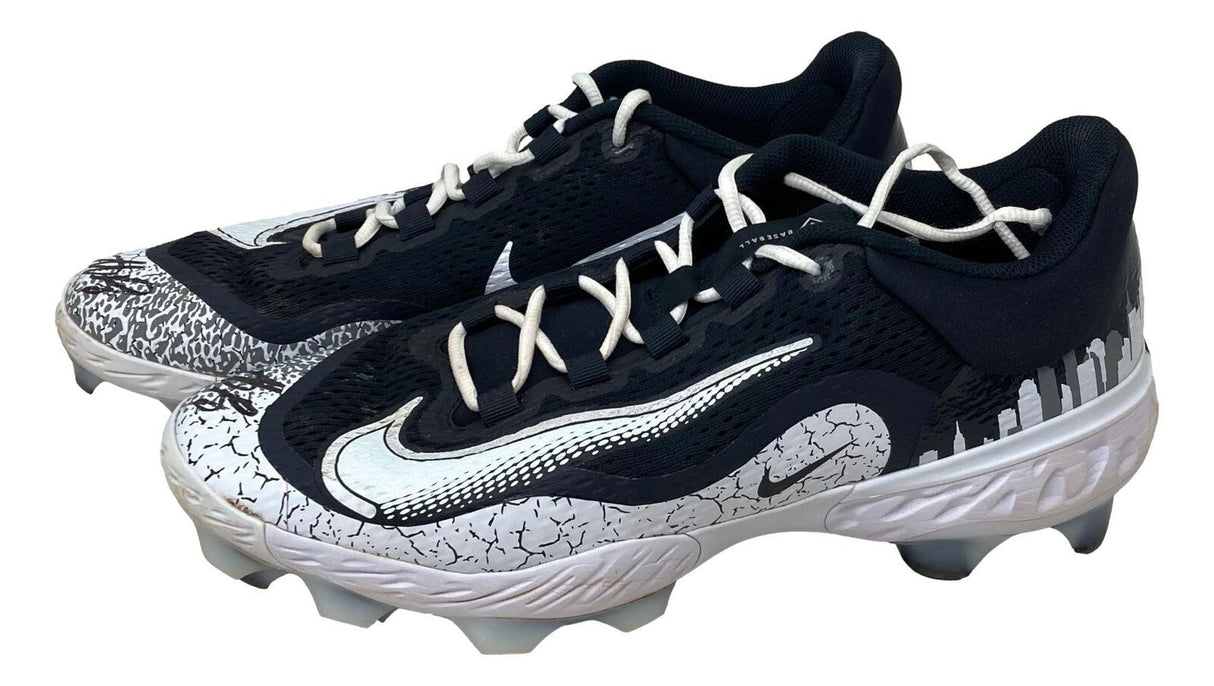 A pair of Anthony Rizzo Signed 2024 Game Used Yankees Nike Cleats by Sports Integrity, black and white with a silver swoosh, city skyline graphics on the heel, and cracked pattern on toe and sole.
