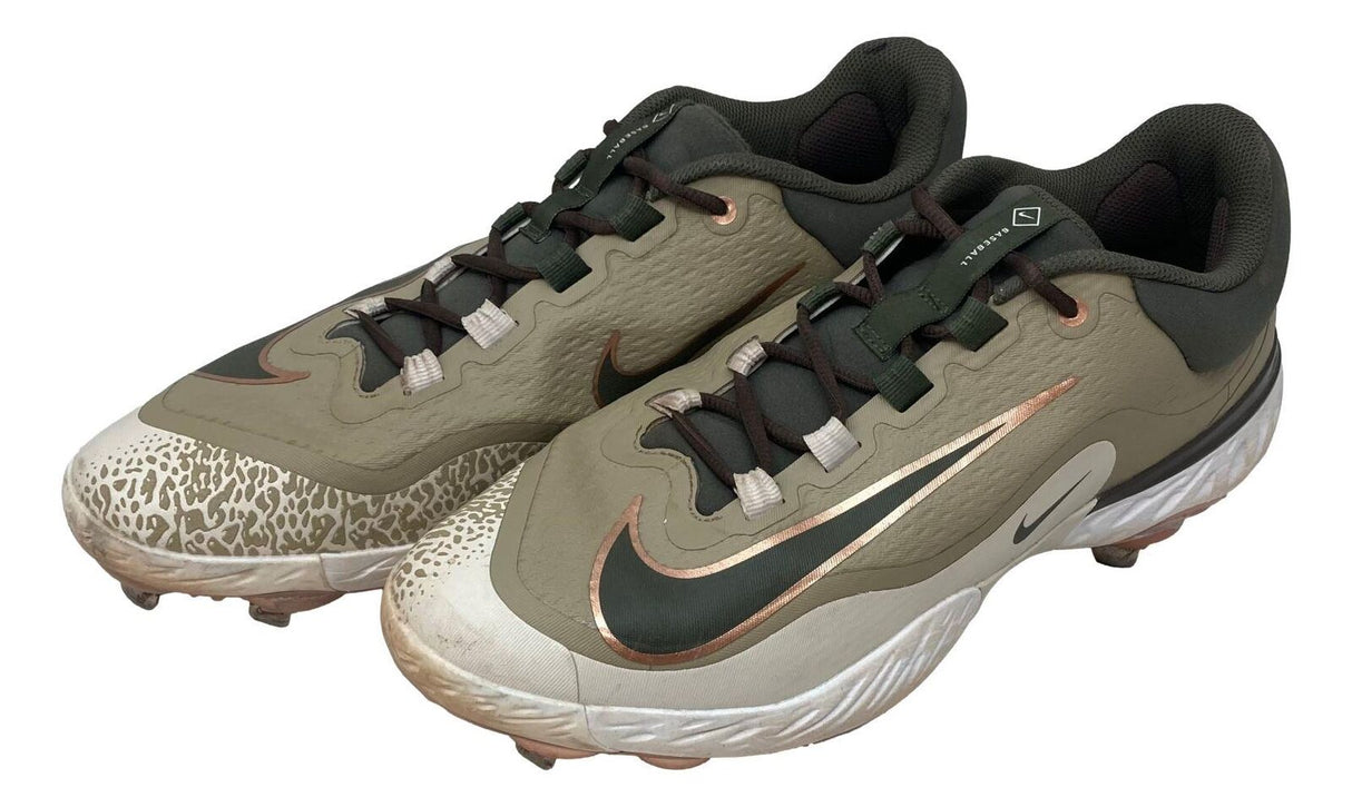 Adley Rutschman 2024 Game Used Baltimore Orioles Nike cleats by Sports Integrity, featuring olive green and tan colors with black and copper accents, white laces, patterned toe detailing, and plastic cleat soles.