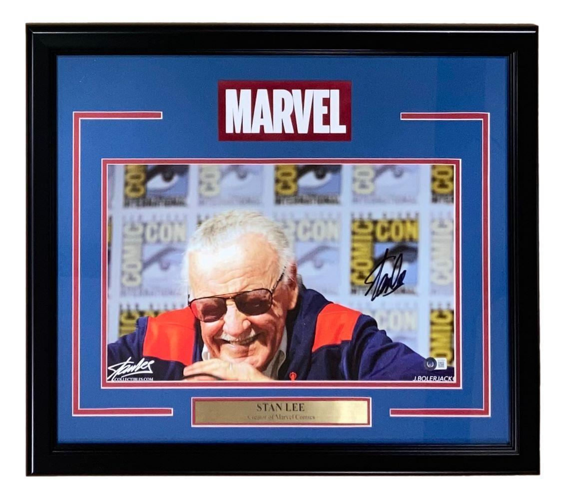 The Sports Integrity Stan Lee Signed Framed 12x18 Marvel Panoramic Photo 2 BAS LOA features a framed photo of Stan Lee, blue and red matting, a Marvel logo above, and a nameplate reading "Stan Lee, Creator of Marvel Comics.