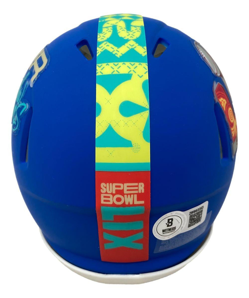 The Brandon Graham Signed Philadelphia Eagles Super Bowl LIX Mini Speed Helmet by Sports Integrity features a blue design, yellow and green center stripe, red SUPER BOWL LIX label on the back, plus certification and barcode stickers.
