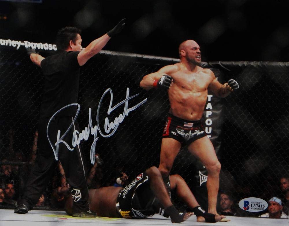Randy Couture Signed MMA 8x10 Photo With Belt- Beckett Auth *Ref Facing Couture