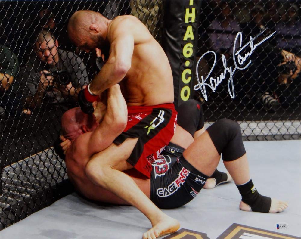 Randy Couture Autographed MMA 16x20 On Top Punching Photo- Beckett Auth *White