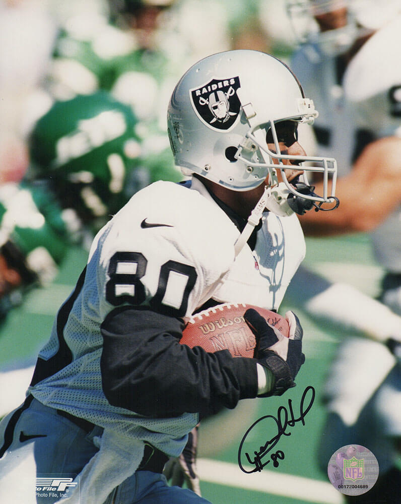 Desmond Howard Signed Raiders White Jersey Close Up With Football 8x10 Photo