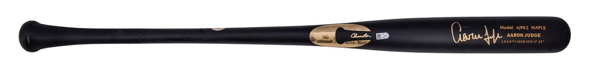 The Sports Integrity Aaron Judge New York Yankees Signed Chandler AJ99.2 Game Model Bat features a black wooden design with gold accents, a stylized signature, and brand logo near the barrel.