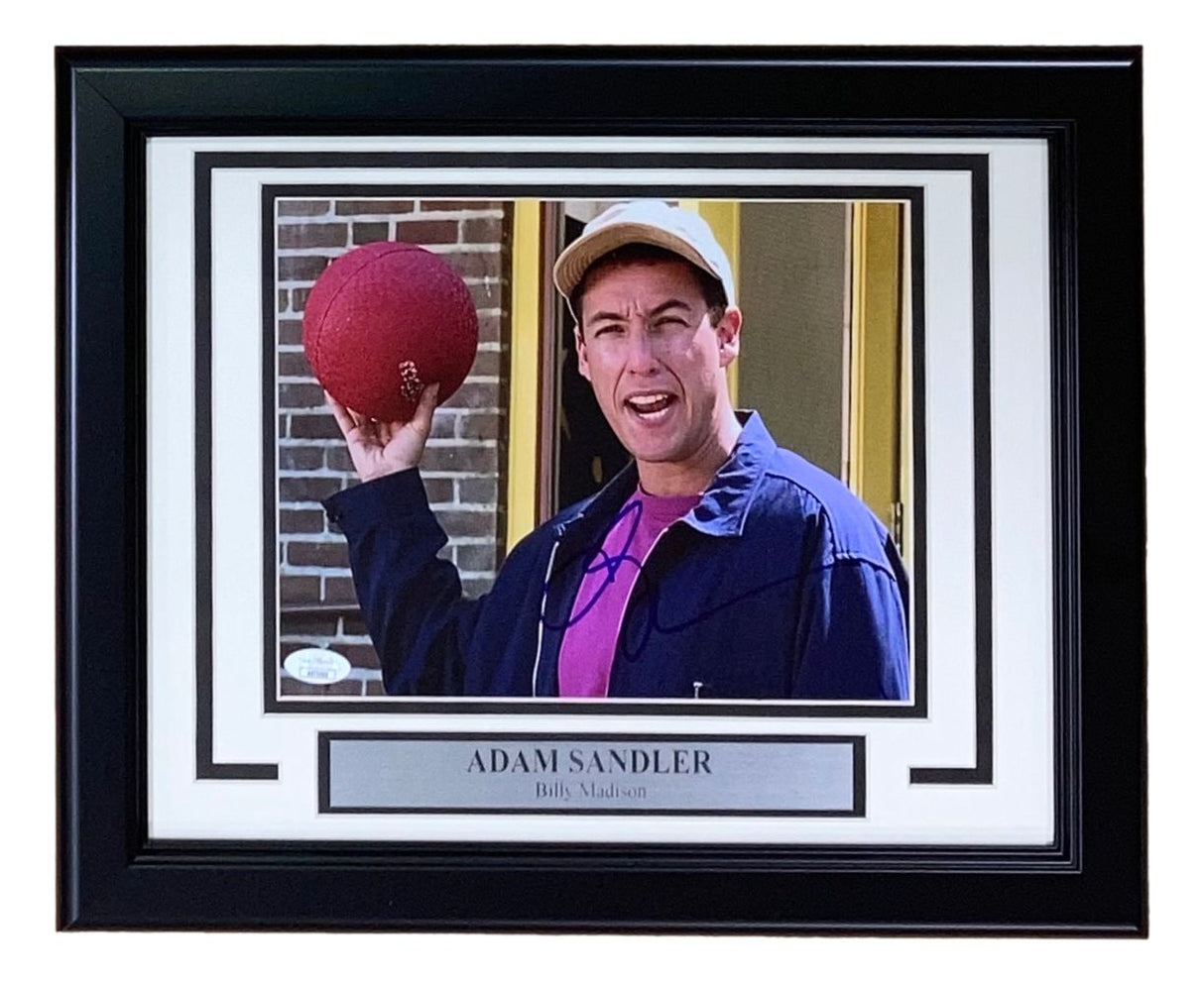 The Sports Integrity Adam Sandler Signed Framed 8x10 Billy Madison Dodgeball Photo features Adam Sandler holding a red dodgeball and smiling, complete with JSA authentication.