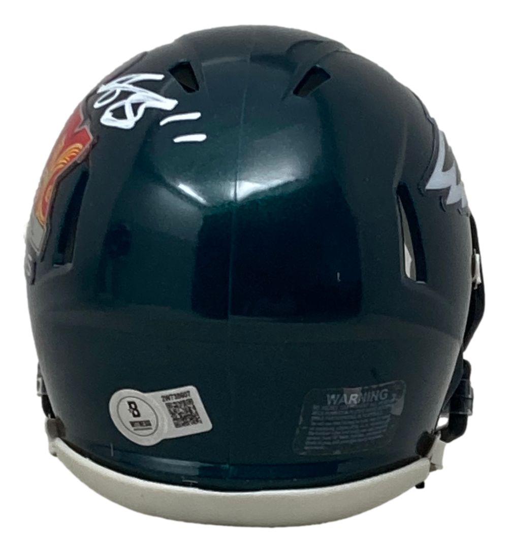 A Sports Integrity AJ Brown Signed Philadelphia Eagles Super Bowl 59 Mini Speed Helmet is shown from the back, displaying an autograph, barcode sticker, warning label, and part of the team logo.