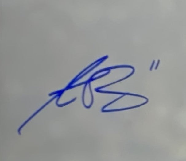 A blue ink signature with looping, connected strokes and a double quotation mark appears on the AJ Brown Signed Framed 16x20 Philadelphia Eagles Photo by Sports Integrity.
