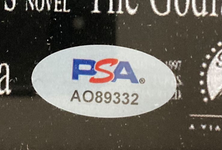 An oval PSA/DNA sticker with blue and red lettering and code AO89332 is affixed to the Al Pacino Signed Framed 11x17 The Godfather Photo by Sports Integrity.