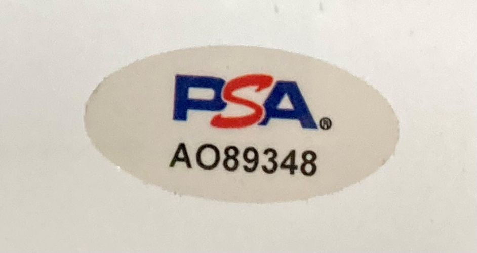 Sports Integrity oval sticker with blue and red PSA letters and black code AO89348, authenticating the Al Pacino Signed Framed 11x17 Scarface Photo PSA/DNA.