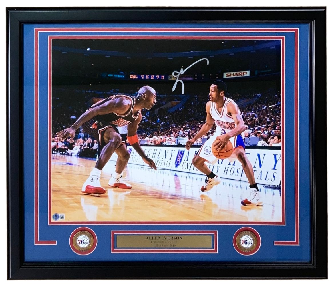 The Sports Integrity Allen Iverson Signed Framed 16x20 Philadelphia 76ers Photo vs Michael Jordan features Iverson dribbling in an NBA game, autographed and matted, ideal for collectors.