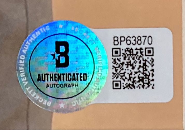 A holographic sticker labeled B Authenticated Autograph sits by a QR code and the code BP63870 on the Annika Sorenstam Signed Framed 11x14 LPGA Golf Photo BAS from Sports Integrity, shown on a beige surface.