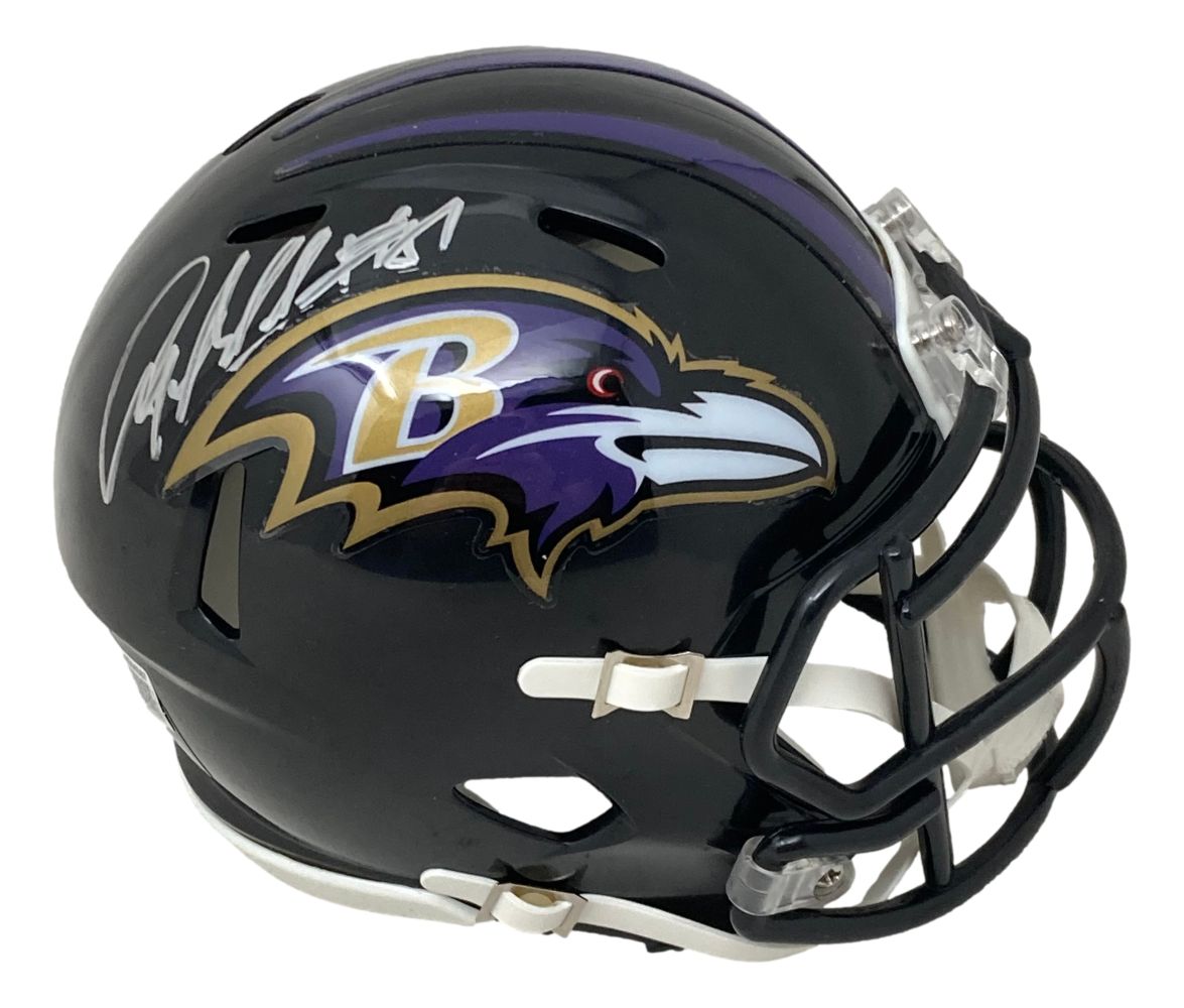 The Sports Integrity Anquan Boldin Signed Baltimore Ravens Mini Speed Helmet features a black shell, purple and gold raven logo, white faceguard, and Boldin’s autograph in silver on top.