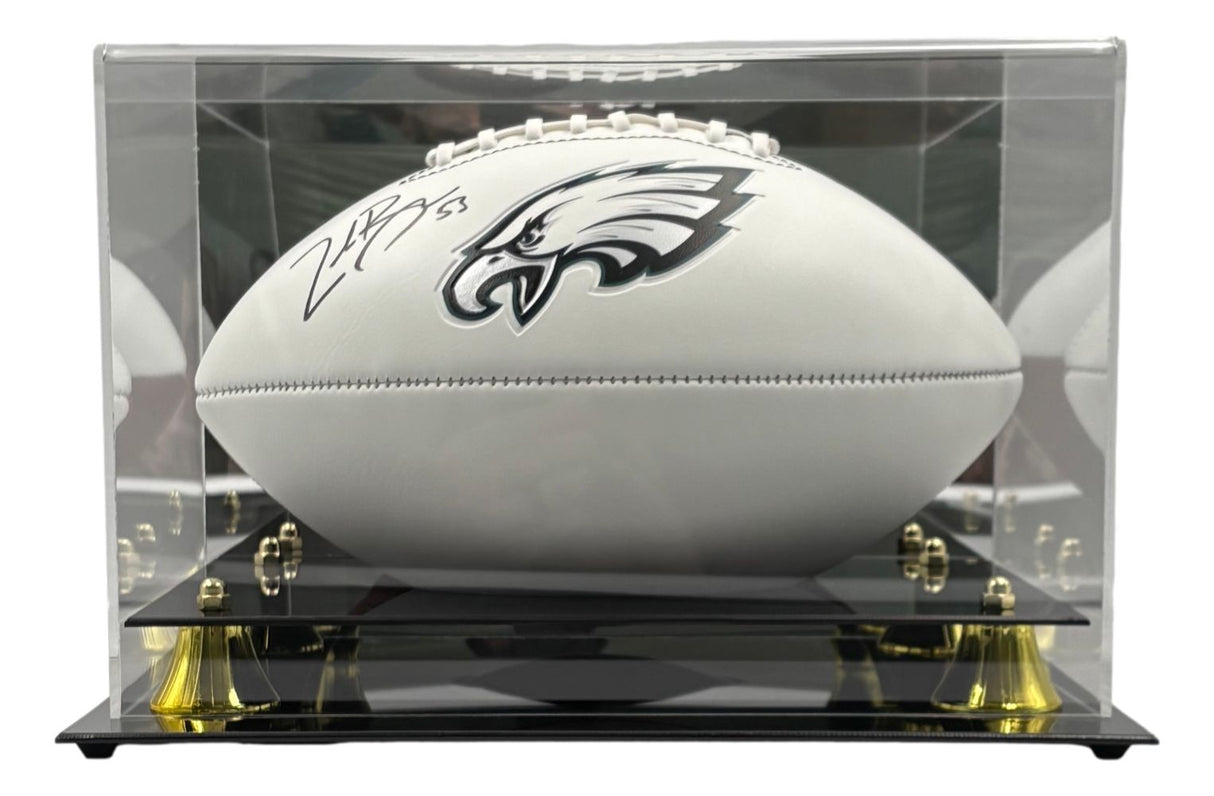 The Sports Integrity Zack Baun Signed Philadelphia Eagles Logo Football is showcased in a clear display case with gold accents and a black base.