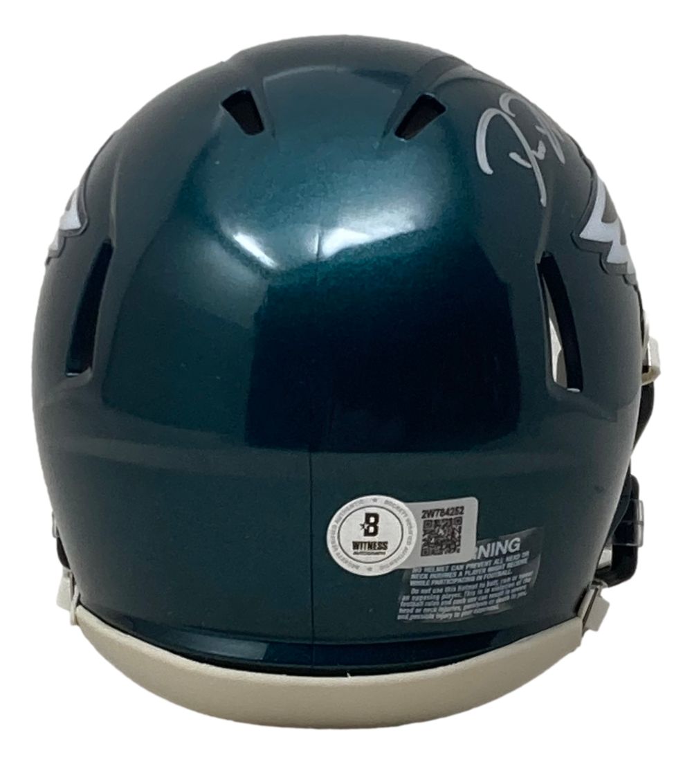 The Sports Integrity Big Dom DiSandro Signed Philadelphia Eagles Mini Speed Helmet BAS features a dark green finish, white chin strap and trim, ventilation slots, barcode sticker, white label, and a signature on the top right.
