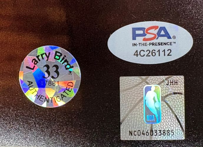 The Larry Bird Signed 16x20 Boston Celtics vs Lakers Photo by Sports Integrity features a holographic Larry Bird 33 AUTHENTICATED sticker, a PSA sticker with code 4C26112, and an NBA silver basketball logo sticker (NC04603388).