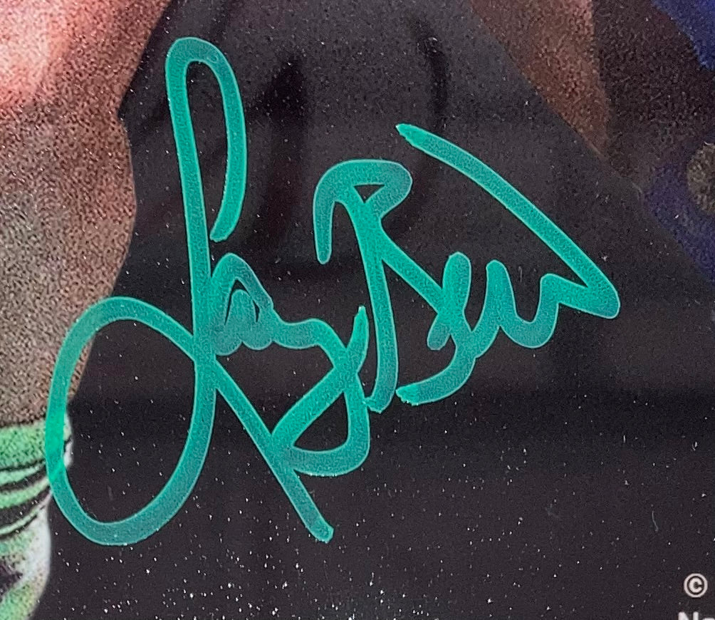 A close-up of Larry Bird’s bold green signature on a glossy 8x10 Boston Celtics photo vs Magic Johnson, authenticated by PSA ITP. Product: Larry Bird Signed Framed Photo. Brand: Sports Integrity.