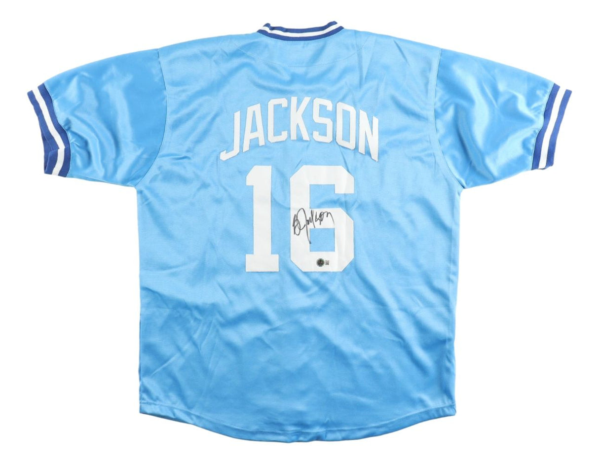 The Sports Integrity Bo Jackson Kansas City Signed Light Blue Baseball Jersey BAS features white letters and numbers, "JACKSON" and 16 on the back with a black autograph, plus blue and white striped trim on the sleeves and collar.