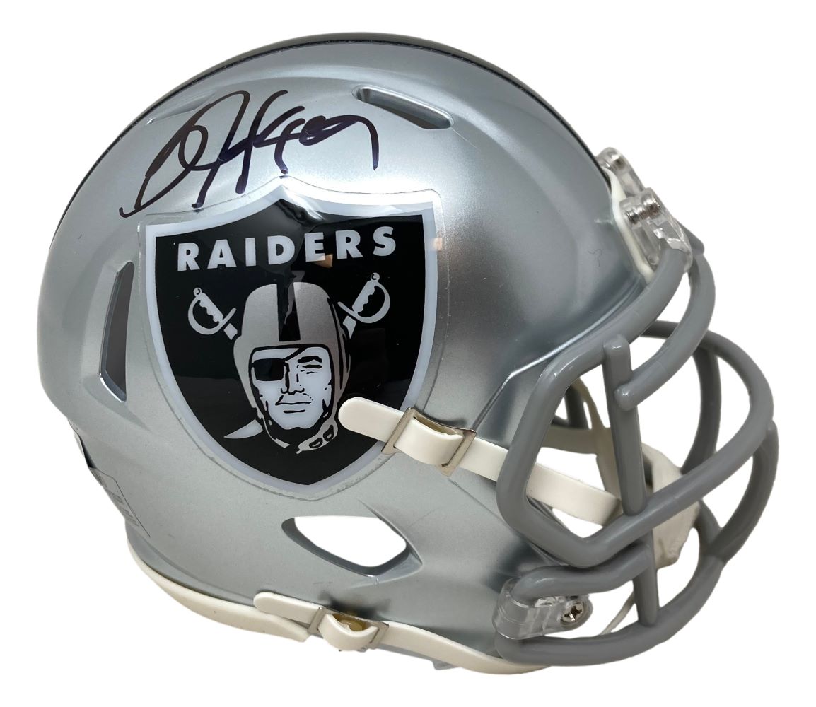 A Bo Jackson signed Oakland Raiders mini speed helmet by Sports Integrity, featuring the black and white Raiders logo, silver shell, and Bo's signature in black marker.