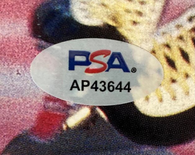 A close-up of a Bonnie Blair Signed Sports Illustrated Magazine (Feb 24, 1992) authenticated by PSA/DNA, showing the PSA logo in blue and red above code AP43644 on a colorful, blurred background. Brand: Sports Integrity.