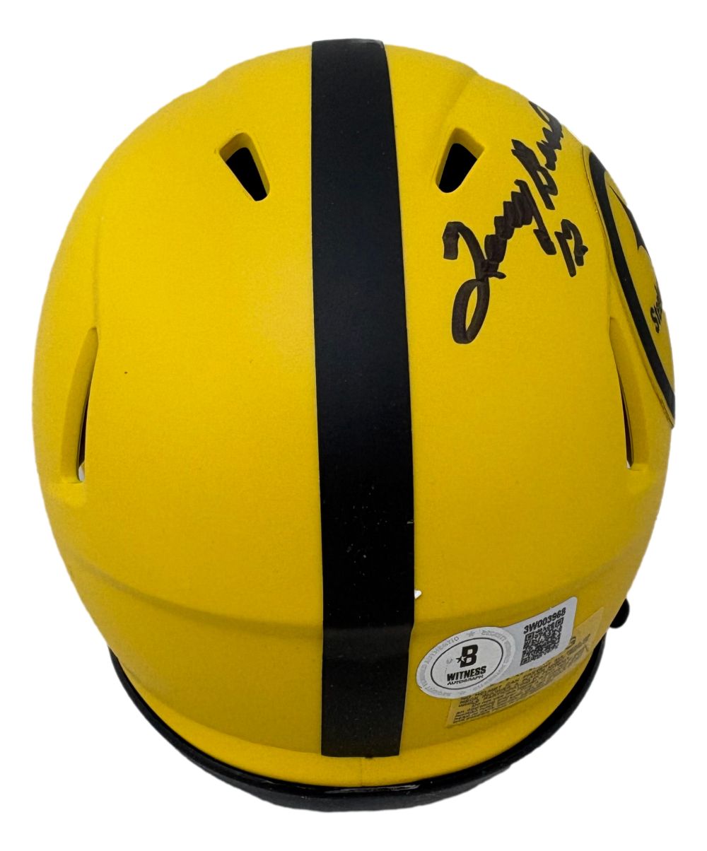 The Sports Integrity Terry Bradshaw Signed Pittsburgh Steelers Rave Mini Speed Helmet BAS features a yellow shell with a black stripe, multiple air vents, a black autograph on one side, and an authentication QR code sticker near the bottom.