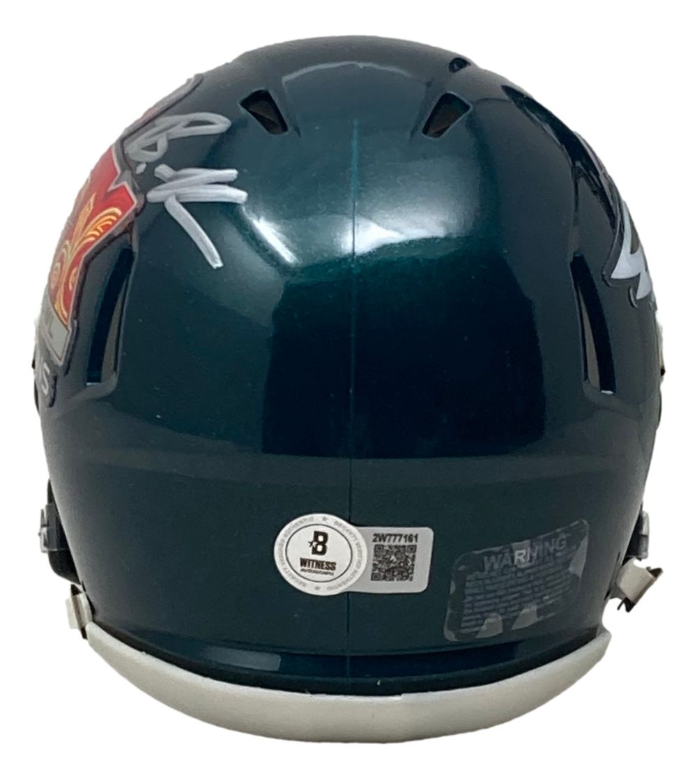 A Brandon Graham Signed Philadelphia Eagles Super Bowl 59 Mini Speed Helmet by Sports Integrity, dark green with white autographs on both sides, a QR code authentication sticker, and a white chinstrap.