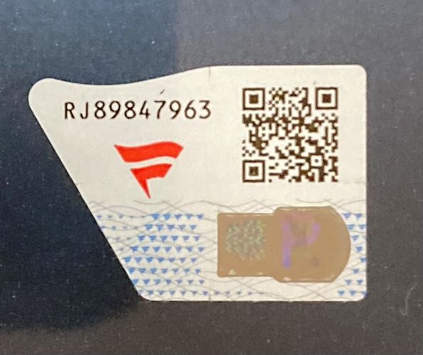 A sticker for the Bron Breakker Signed Framed 16x20 WWE Photo Fanatics by Sports Integrity, featuring code RJ89847963, a red logo, QR code, and metallic security feature on a white background with blue patterns.