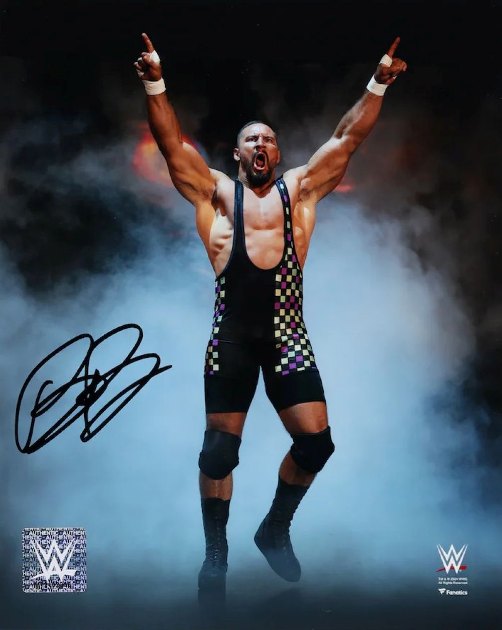 Bron Breakker raises his arms in a cloud of smoke on this signed 8x10 WWE photo from Sports Integrity, featuring two WWE logos and his autograph in the lower left corner.