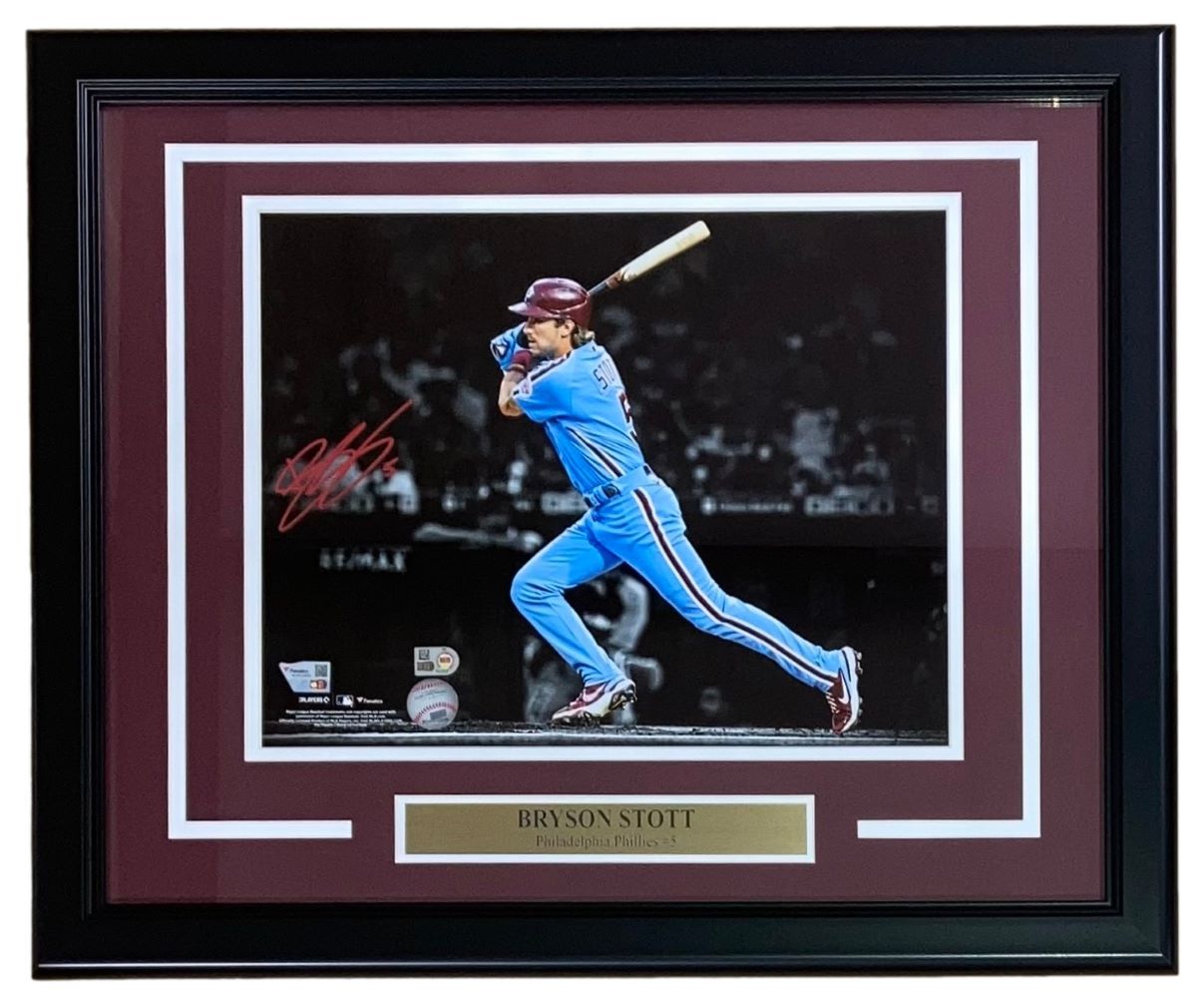 Bryson Stott Signed Framed 11x14 Philadelphia Phillies Photo by Sports Integrity features Stott mid-swing in a blue uniform, his red signature, and a plaque reading “Bryson Stott, Philadelphia Phillies #5.”.
