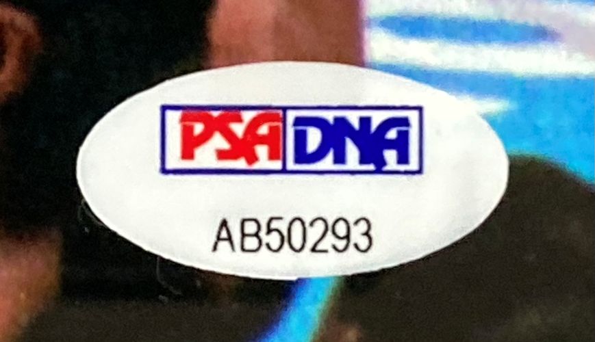 Close-up of a PSA/DNA sticker with ID AB50293 on the Sports Integrity Buster Douglas Signed Framed 8x10 Mike Tyson Knockout Photo.