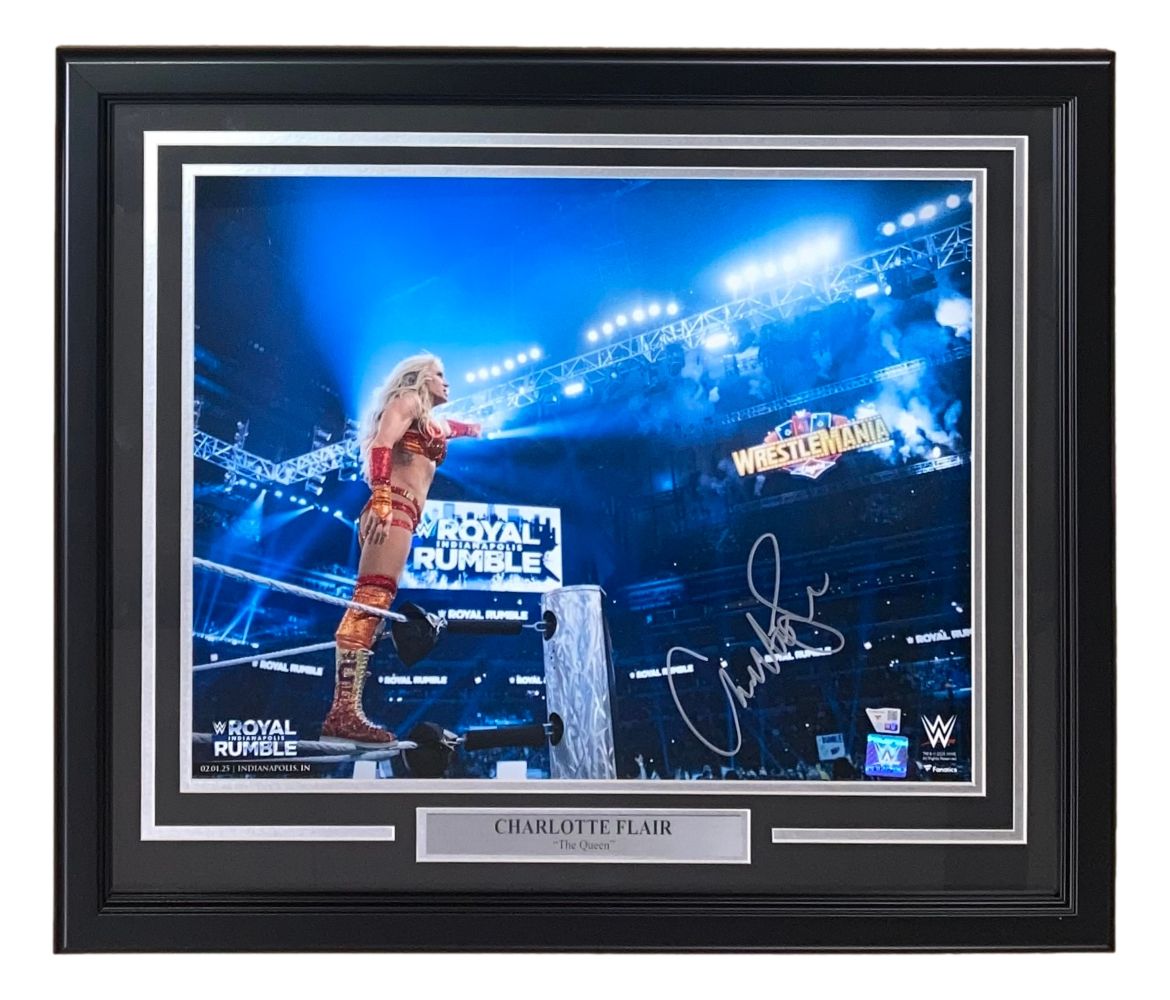 Sports Integrity Charlotte Flair Signed Framed 16x20 WWE 2025 Royal Rumble Photo shows Flair on the ropes with arena lights and a WrestleMania sign. Includes plaque reading "Charlotte Flair The Queen.