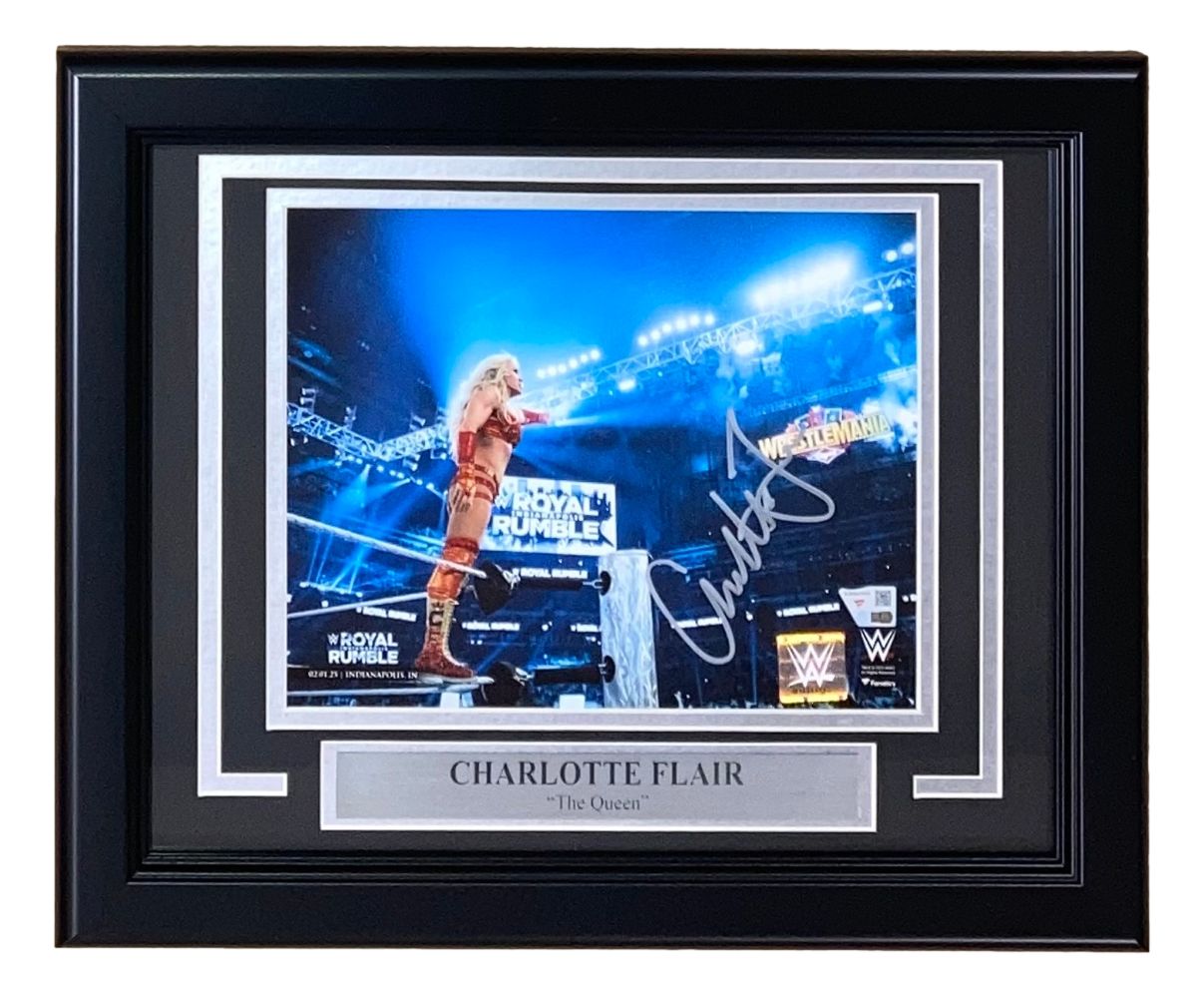 Sports Integrity Charlotte Flair Signed Framed 8x10 WWE 2025 Royal Rumble Photo features Flair on the ring ropes, with stadium lights and Royal Rumble signs, plus a nameplate reading: “Charlotte Flair ‘The Queen.’”.