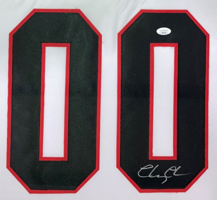 This Sports Integrity Chevy Chase Signed Framed Lampoon’s Christmas Vacation White Griswold Jersey features large black number 00 with red borders on white; the right zero has Chevy Chase’s autograph and a JSA authentication sticker above it.