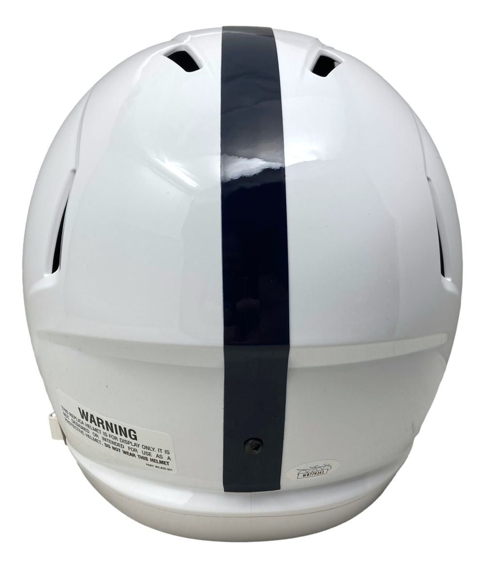 A Dani Dennis-Sutton signed Penn State full size speed replica helmet by Sports Integrity, featuring a white design with a single dark blue vertical stripe down the center and a visible warning label near the bottom.