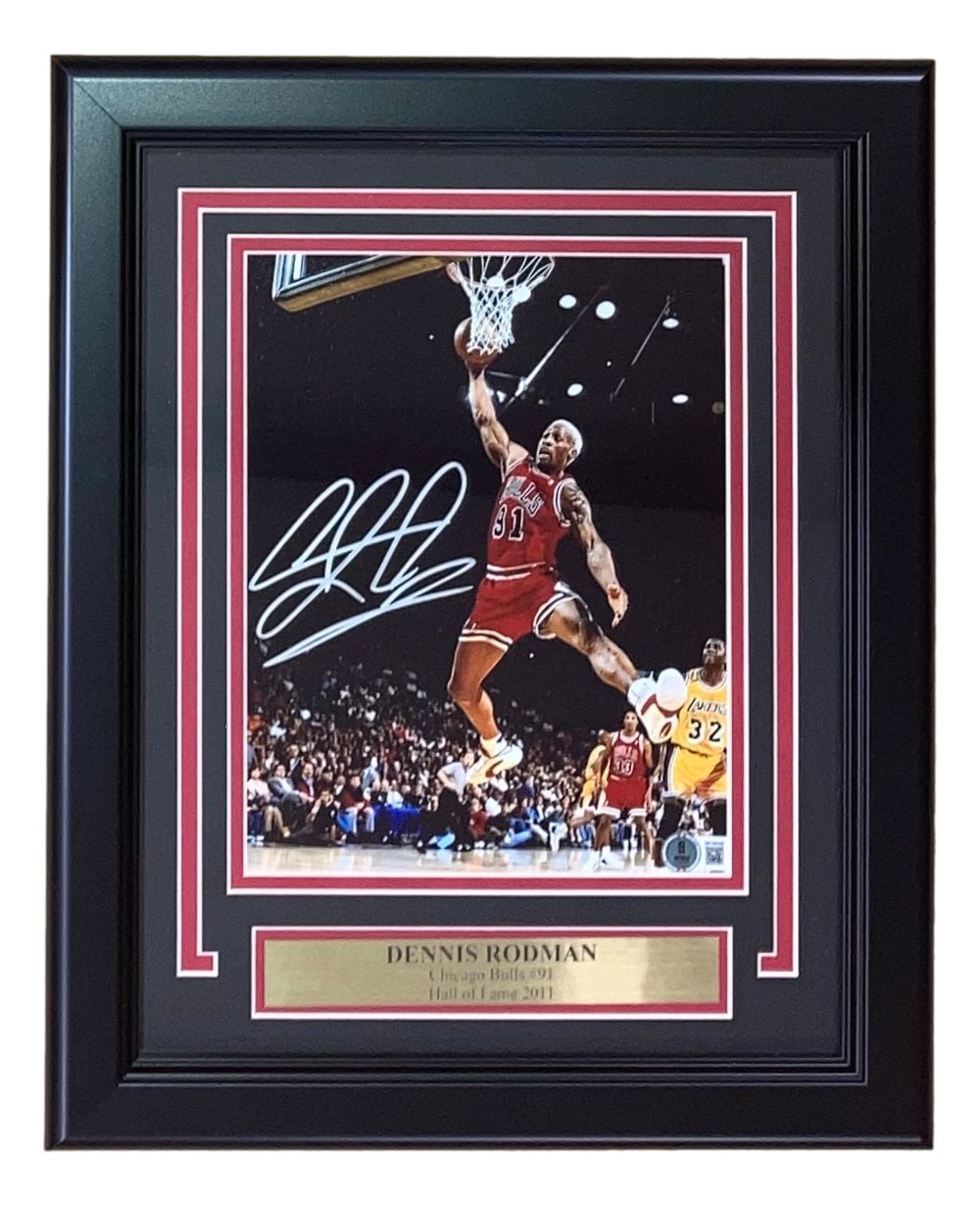 Sports Integrity Dennis Rodman Signed Framed 8x10 Chicago Bulls Photo BAS features a framed, autographed game-action shot of Rodman (#91), perfect for fans and collectors.