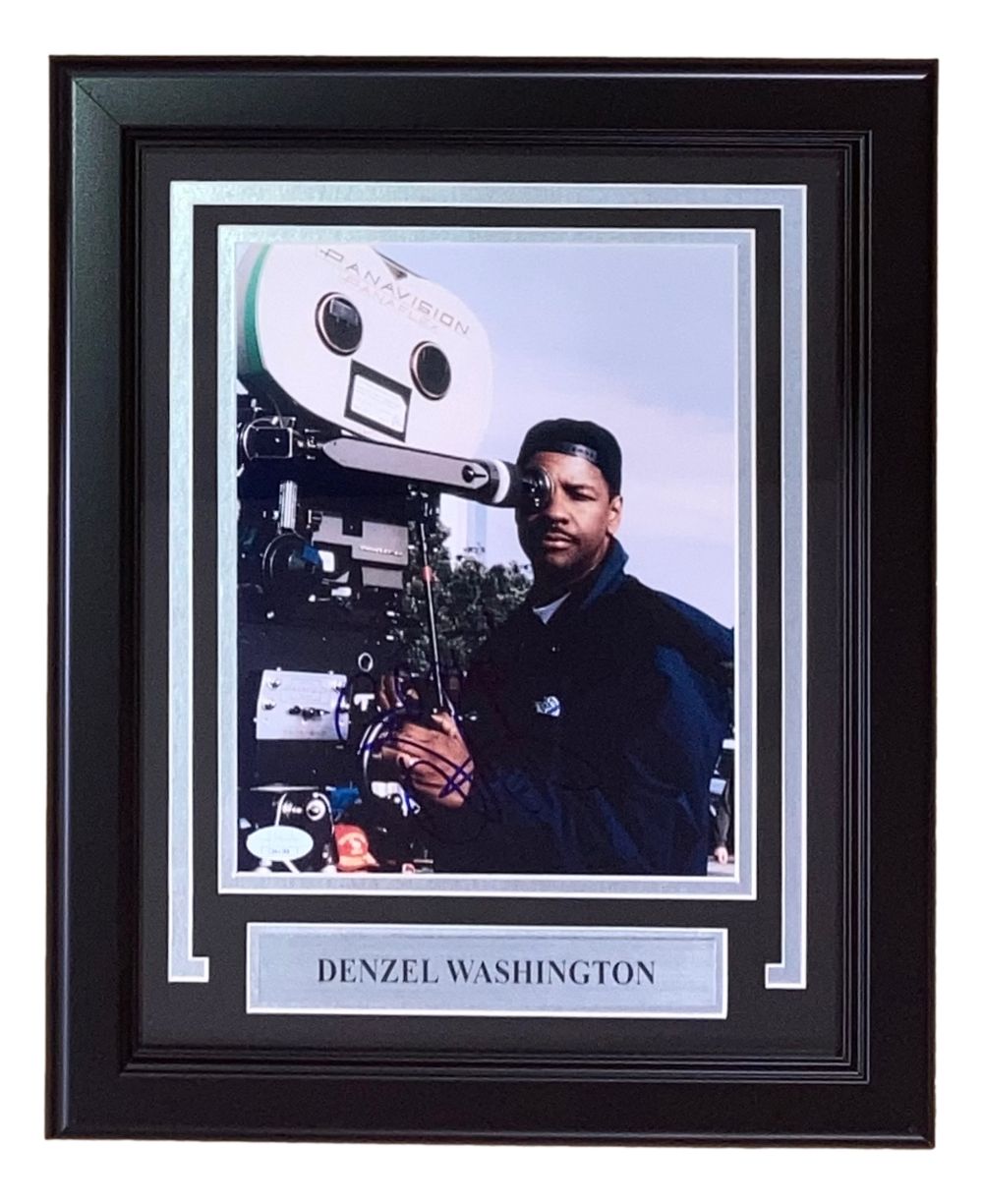 The Sports Integrity Denzel Washington Signed Framed 8x10 Photo (JSA) features Denzel in dark clothing beside a vintage film camera, with a nameplate below his image.