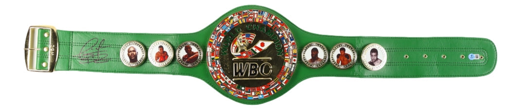 The Deontay Wilder Signed Full Size Replica Boxing Championship Belt by Sports Integrity features a green strap, large gold central plate with flags, boxer photos on each side, and a black signature on the left strap.