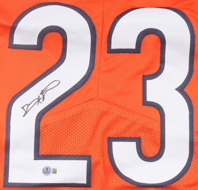 The Sports Integrity Devin Hester Chicago Signed Orange Pro-Cut Football Jersey BAS features white number 23 outlined in blue, black marker signature on the left side, and an authentication sticker near the bottom.